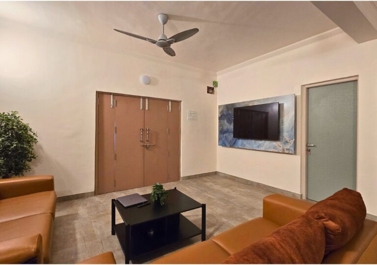 Vandana Villa, Alibag: Living hall with a wall-mounted TV