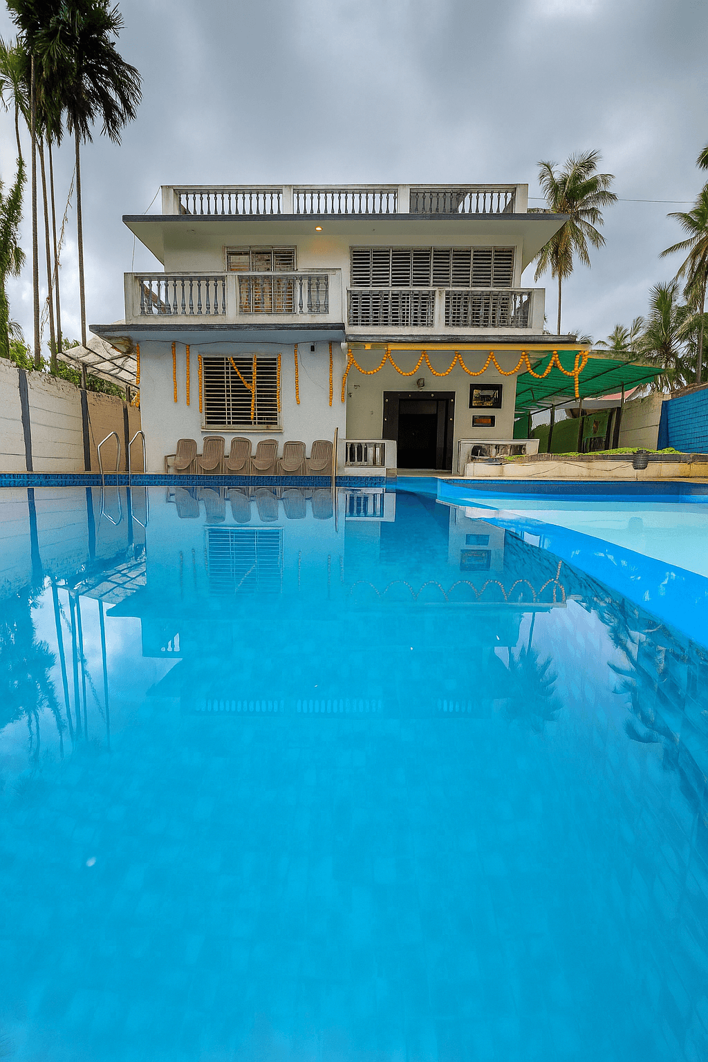 Vandana villa Alibag home 4 Vandana Villa poolside lawn seating
