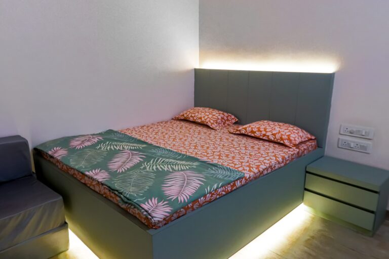 Vandana Villa, Alibag: AC bedroom with a lit headboard