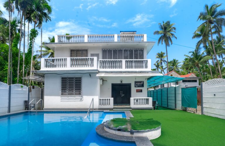 Vandana Villa, Alibag: The villa, the private pool and the turf lawn on a clear day