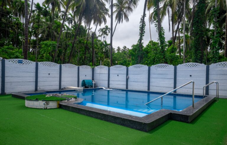 Vandana Villa, Alibag: The pool along the white compound wall